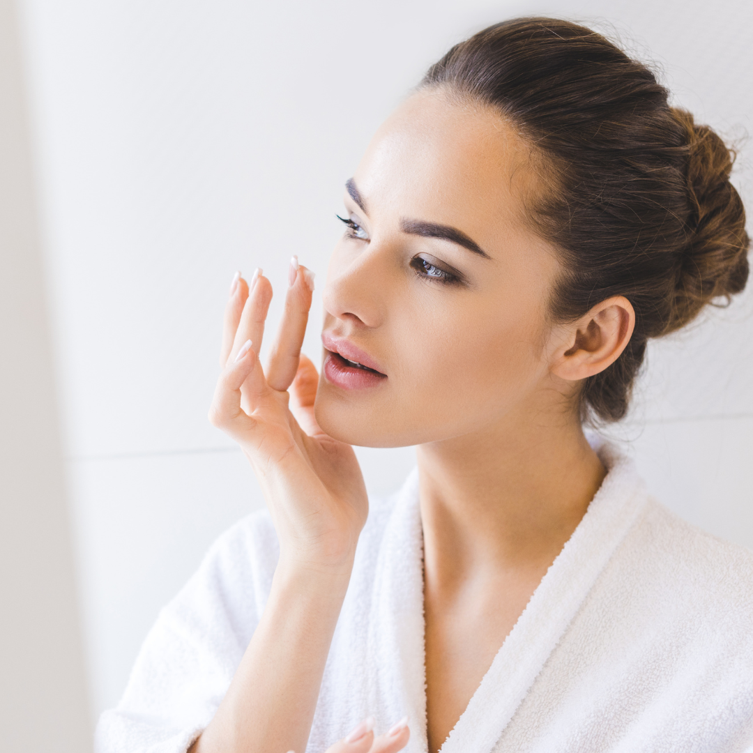 woman applying face serum