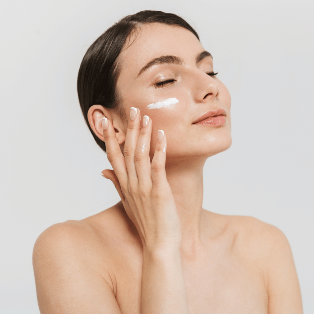 woman applying moisturizer to skin