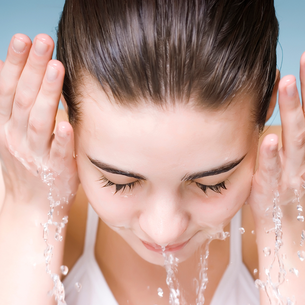 woman washing her face